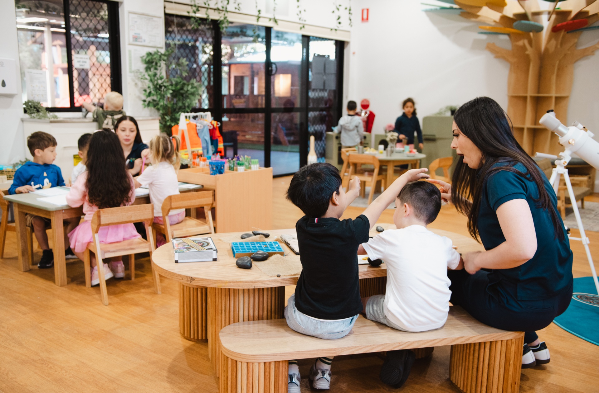 Educator engaging warmly with a child at Strive